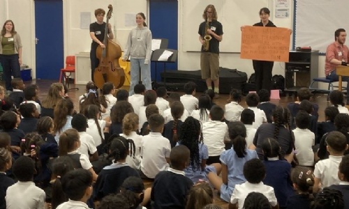 Latymer students in front of young pupils
